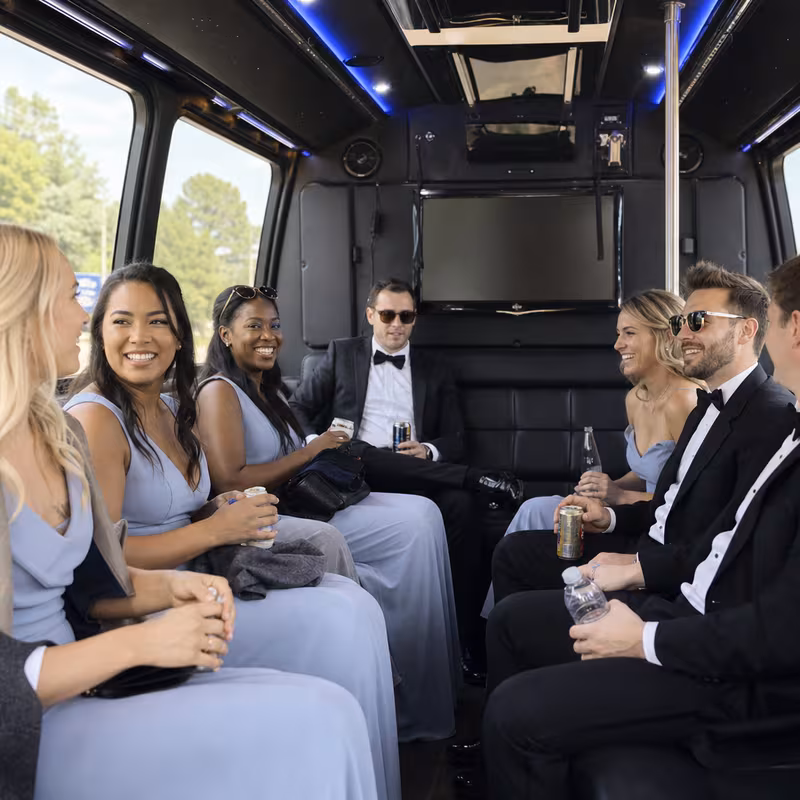 Wedding guests seated inside a Little Rock party bus