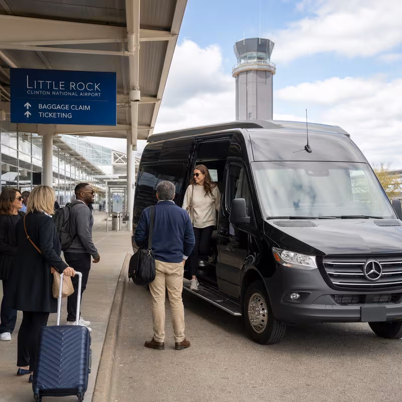 Group boarding a white charter bus for Airport Transportation transportation in Little Rock
