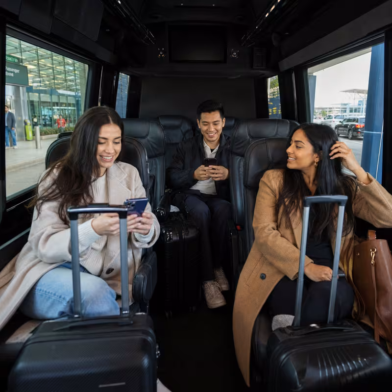 Passengers loading luggage while boarding an Little Rock group shuttle