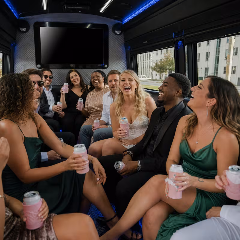 Party bus interior with wraparound leather seating and LED lighting in Little Rock