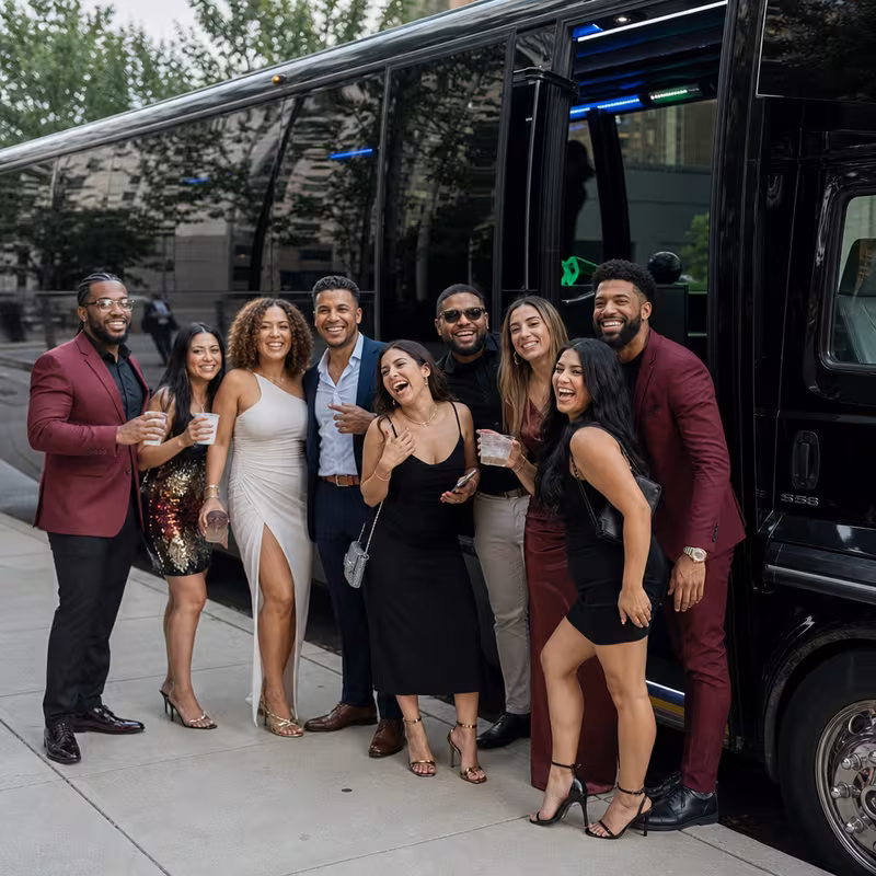 Group boarding a white charter bus for Birthday Transportation transportation in Little Rock