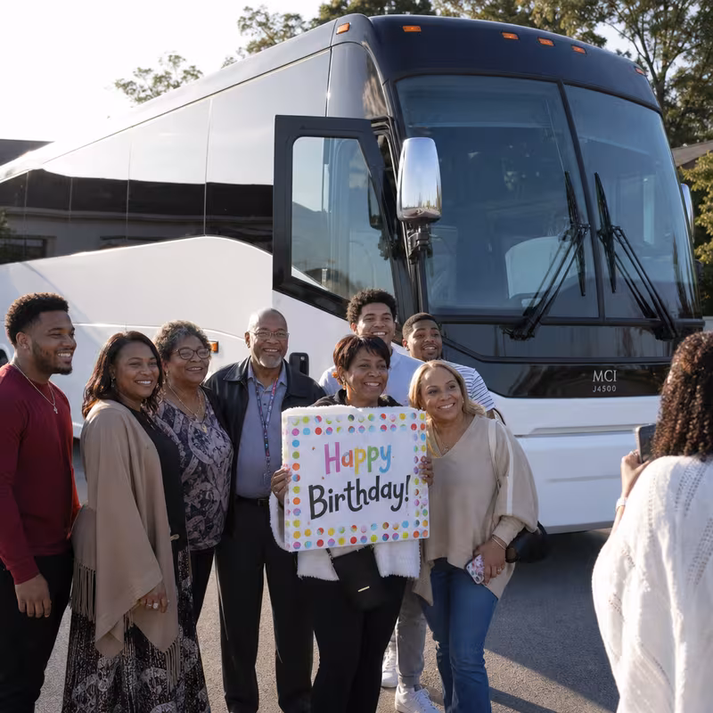 Passengers loading luggage while boarding an Little Rock group shuttle