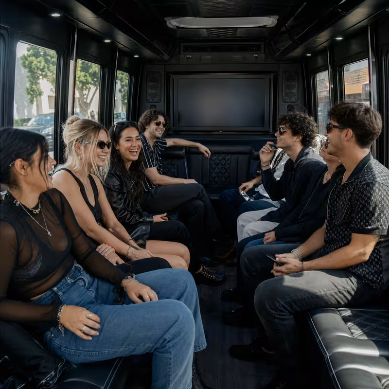 Group boarding a white charter bus for Concert Transportation transportation in Little Rock