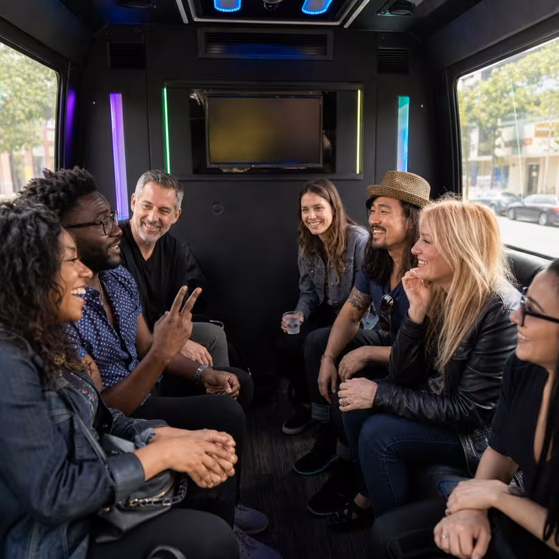 Passengers loading luggage while boarding an Little Rock group shuttle