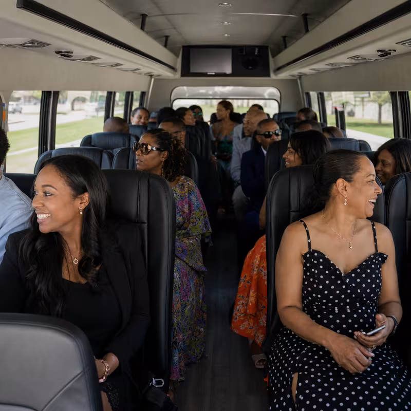 Group boarding a white charter bus for Private Event Transportation transportation in Little Rock