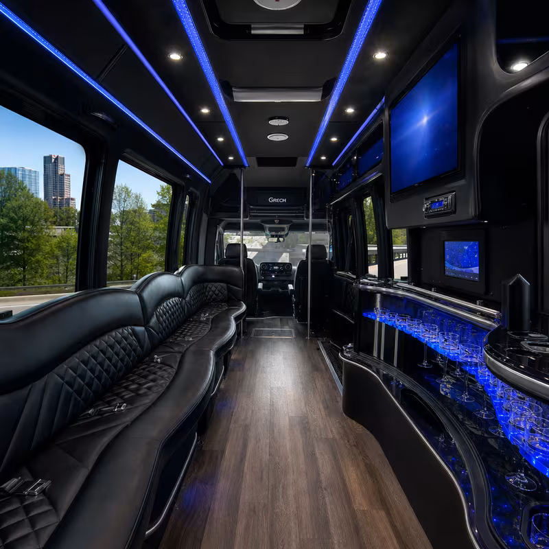 Party bus interior with wraparound leather seating and LED lighting in Little Rock