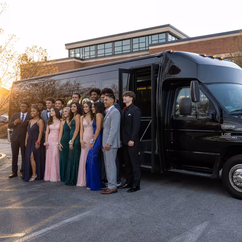 Group boarding a white charter bus for Prom & Homecoming Transportation transportation in Little Rock