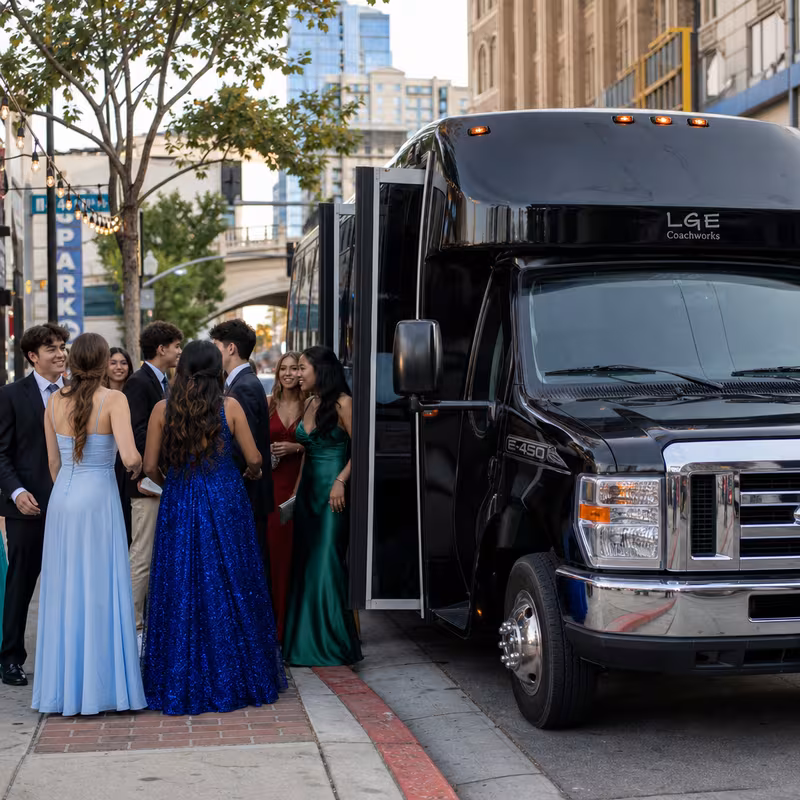 Passengers loading luggage while boarding an Little Rock group shuttle