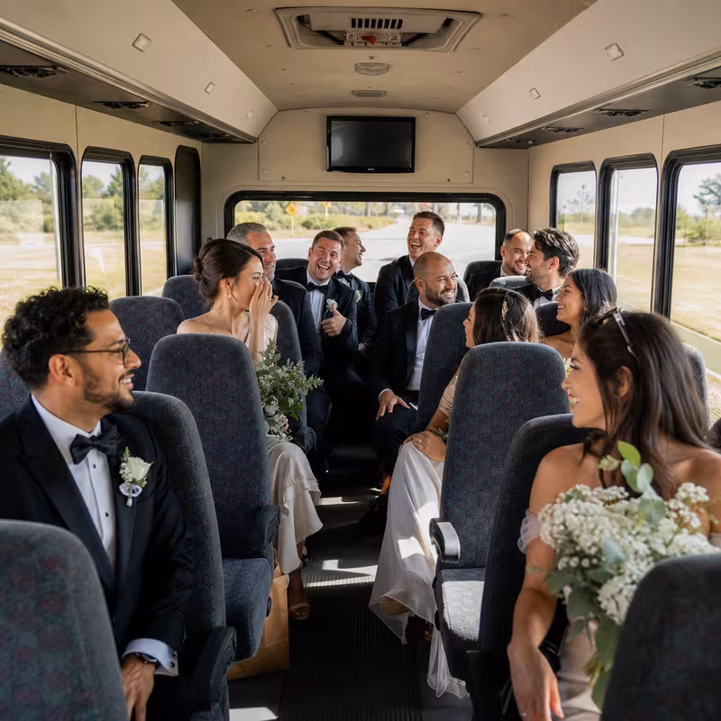 Group boarding a white charter bus for Wedding Transportation transportation in Little Rock