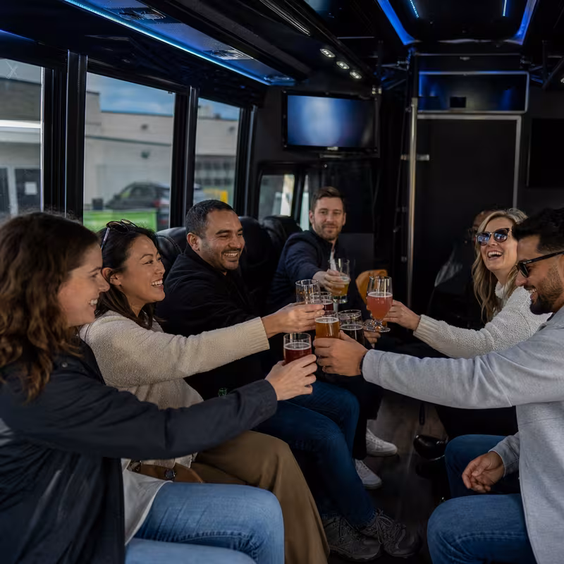 Group boarding a white charter bus for Winery & Brewery Tour Transportation transportation in Little Rock