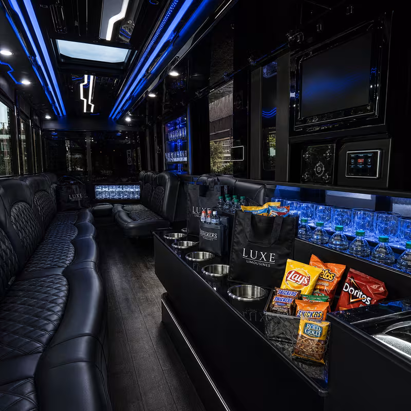 Party bus interior with wraparound leather seating and LED lighting in Little Rock