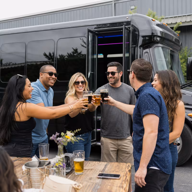Passengers loading luggage while boarding an Little Rock group shuttle